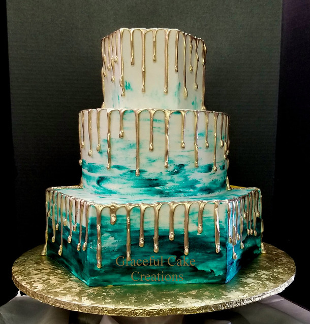 White Butter Cream Wedding Cake with a Teal Ombre Design and White Chocolate Drip painted Gold