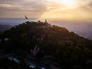 Aerial view of Wat Phra That Doi Suthep Temple at sunrise on the top of Doi Suthep mountain in Chiang Mai, Thailand.