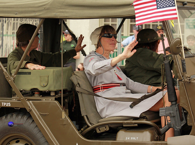 WWII nurse waves in Jeep.