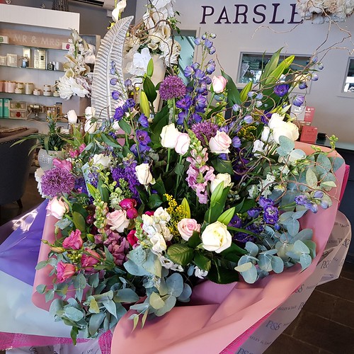 This amazing bouquet of flowers which included the seasons finest delphiniums, alliums, roses, lisianthus and snap dragons ended up being bigger than the Florist who made it!!! 😍💐🌹 #parsleyandsageflorist #bouquets #loveflowers #sho | by parsleyandsage11