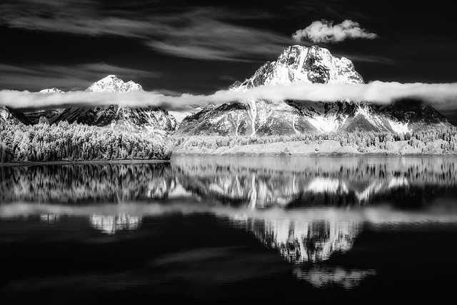 mountains and clouds reflected in Jackson Lake