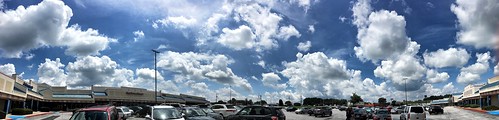 clouds cloudscape midday georgia mariettaga parkinglot cars parkinglotlights buildings stores stevefrenkel iphonese snapseed panorama