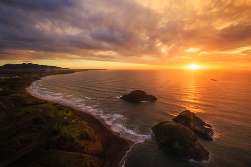 sunset newplymouth newzealand beach glow islands reflection