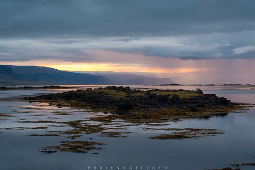 Sunset near Króksfjarðarnes, Westfjords, Iceland by Fabien Guittard, The setting sun ignites the skies of the westfjords of Iceland under the thick layer of clouds that 