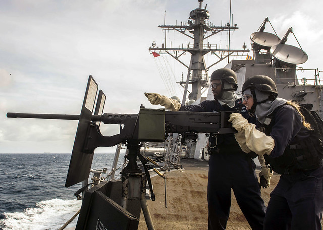 Sailors conduct a live-fire exercise aboard USS Mustin (DDG 89).
