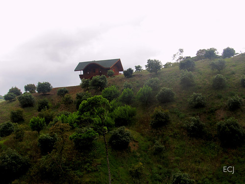 arquitectura vivienda solariega campo rural madera vegetación colina pendiente ladera montaña nubes caminata potrero
