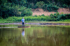 Fisherman in a traditional canoe Hanoi, Vietnam