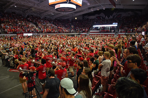 Marching band plays for new students during Convocation in Reynolds Coliseum.
