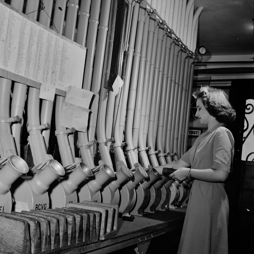 Miss Helen Ringwald works with the pneumatic tubes through which messages are sent to branches in other parts of the city of Washington D.C. for delivery, 1943.