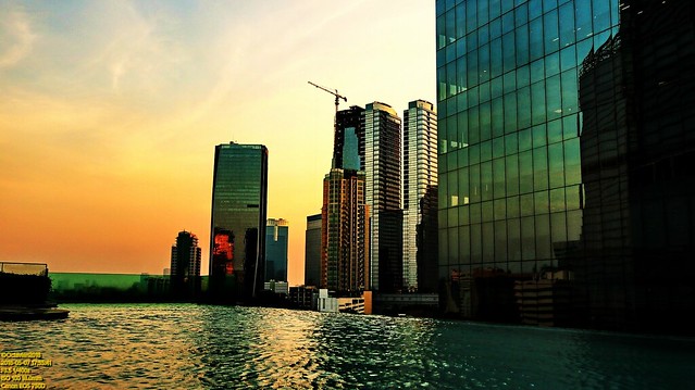 ..infinity pool and the city scape in golden dusk..