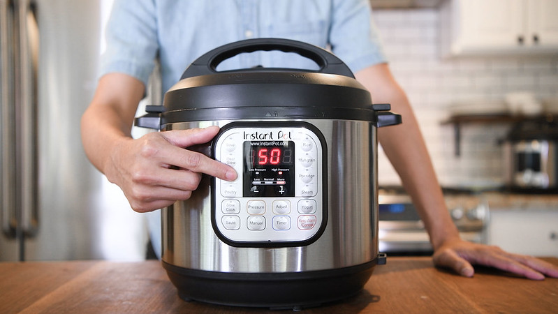 Instant pot pressure cooker set to 50 minutes on high pressure in kitchen