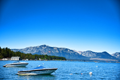 boats boat mountain mountainside mountains water lake blue sky