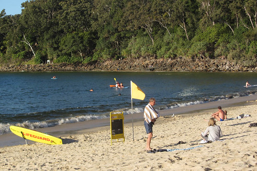 sunshinecoast queensland australia noosa people beach sand water sky trees flags