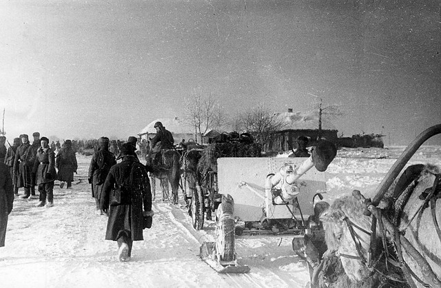 Red Army soldiers horse drawn 76.2-mm  ZIS-3 on a ski chassis past the  village of Soldatskoye 1943.