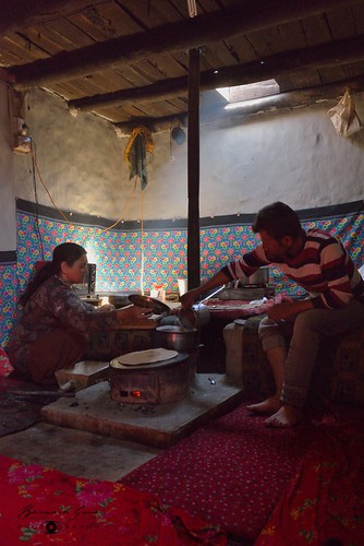 In the house of Mrs Pari Jahan. She prepares chapati on a stove in front of dildung. Kitchen is separated from the main room. © Bernard Grua