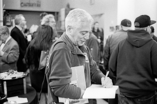 Jim Burger signing books at his photo show at MICA, October, 2017