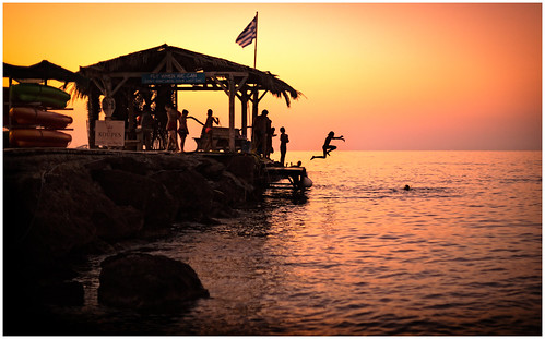 children kids people divers jumping leaping playing pier beach sunset sunrise sea greece crete agia marina fun play silhouette sun colour nightfall twilight childhood flag