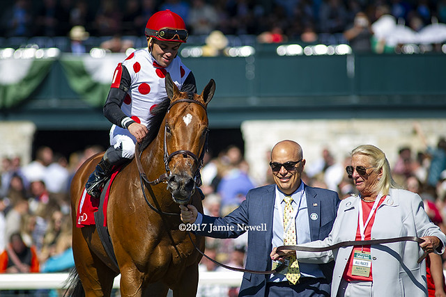 Holding Gold is escorted into the winner's circle at Keeneland