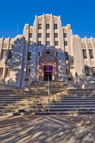 arizona artdeco bisbee cochisecountycourthouse qualityhill royplace superiorcourtofarizona architecture bronzedoord bronzelamps buildings courthouse frontelevation grandstaircase miners miningarchitecture miningtown oldwest portrait publicbuilding shadows stairs stonecarving tripartitefacade tympanum verticle unitedstates us