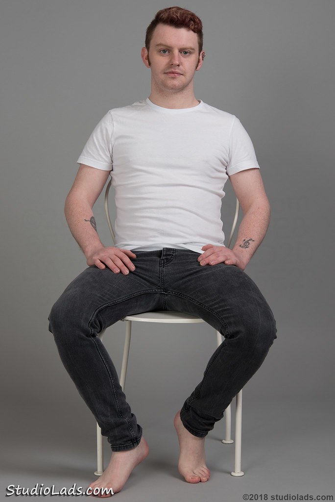 Barefoot guy sitting in jeans