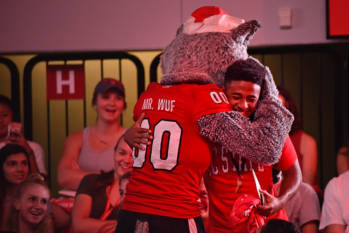 New student gets a big wolf "welcome home"hug from Mr Wuf prior to the start of Convocation in Reynolds Coliseum.