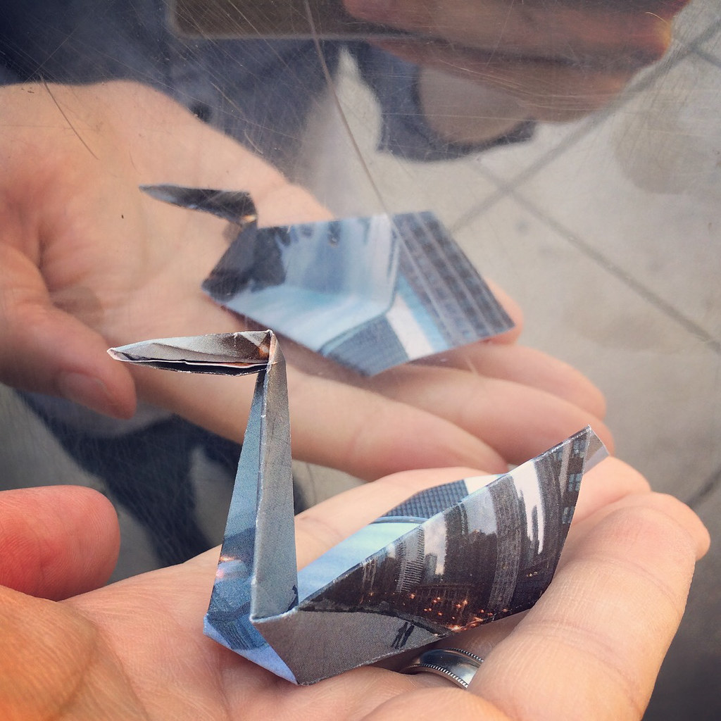 An origami swan folded from a photo of the Chicago Bean.