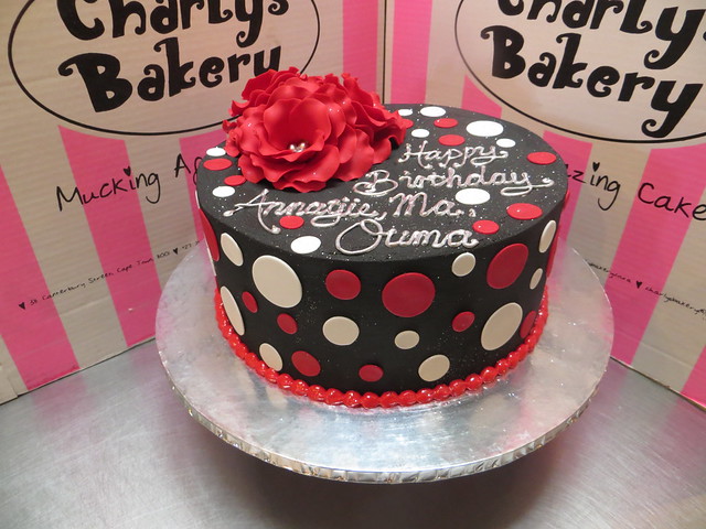 Black, white & red round birthday cake with 3x Red Sugar roses on top and polka dots on sides