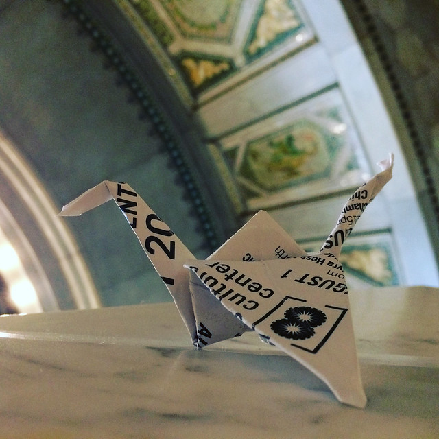 Origami crane hanging out by the south window of the Chicago Cultural Center