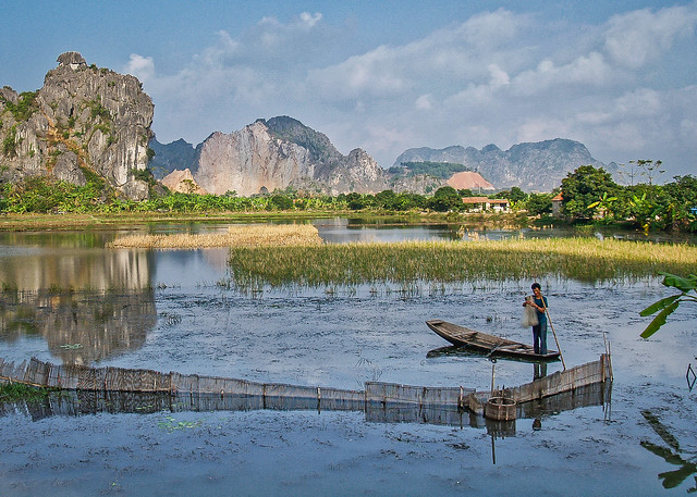 Harvesting the catch from a fishtrap near Ha Long in Vietnam
