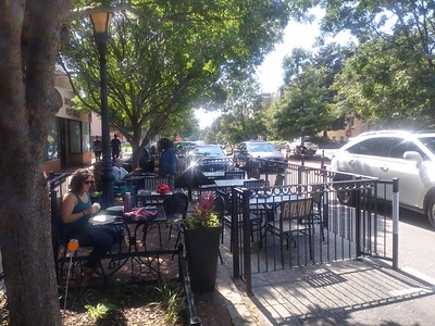 An in-street restaurant patio for Takoma Beverage Co. using parking spaces, Carroll Avenue, Takoma Park, Maryland