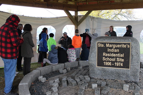 <p>Fall Harvest participants learn about residential schools from a Residential School Survivor</p>