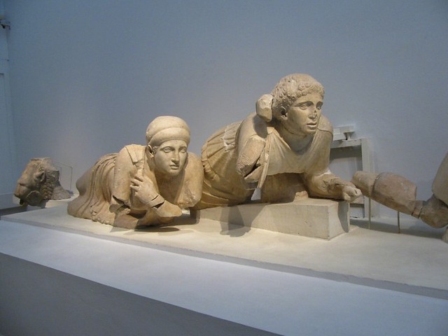 Two female figures huddle down on the left side of the west pediment. The left one is a later addition to replace the original statue that was destroyed for unknown reasons in 460 BC_Museum of Olympia