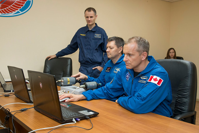 Expedition 57 backup crew members on a laptop training simulator