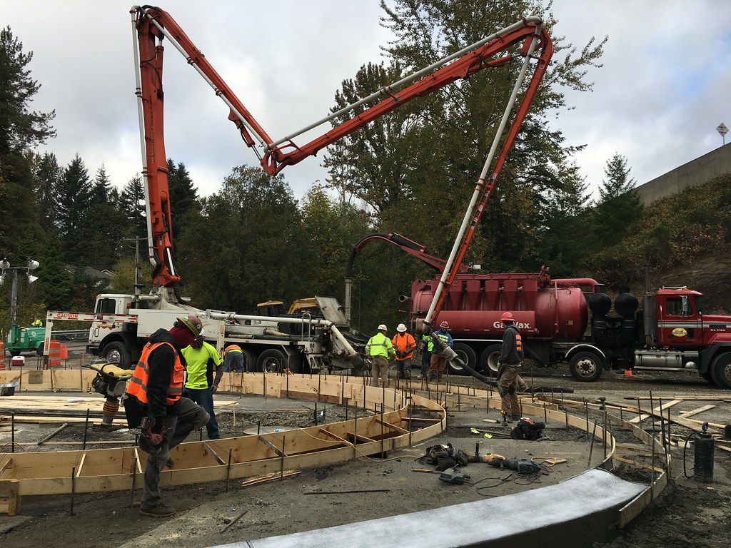Workers pouring concrete on center island of Locust Way roundabout