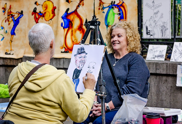 Artist paints portrait for tourist at Jackson Square in New Orleans Louisiana