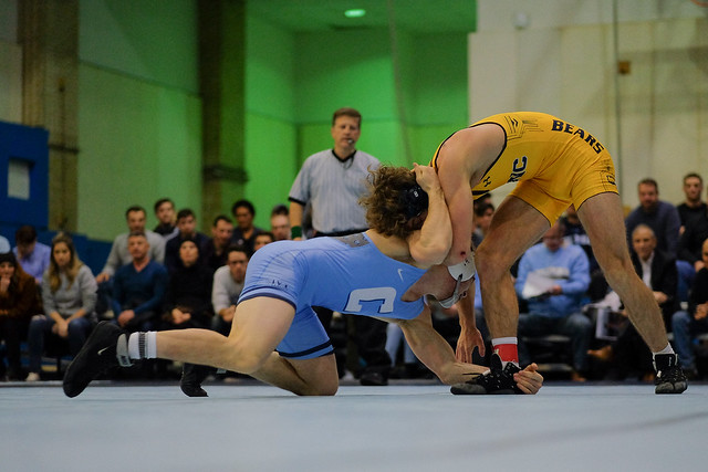 Columbia wrestler (blue) attempts an ankle pick