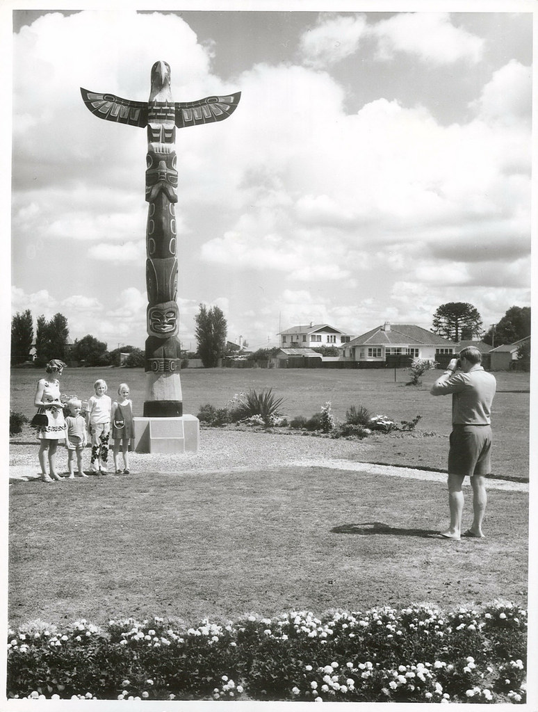 Tourists at the Totem Pole presented to the people of Gisborne by the Canadian Government to commemorate the Bicentenary of the arrival of Captain Cook in NZ