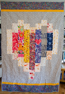 This quilt uses the 'Big Hearted' design (huntersdesignstudio.com/product/big-hearted/) from Hunter's Design Studio with the Quilts for Pulse modification to add rainbow stripes: huntersdesignstudio.com/2016/06/21/big-hearted-modificati...