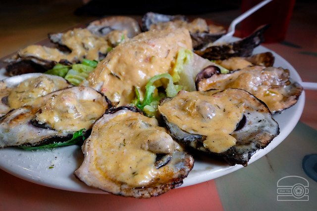 Char Grilled Oysters garlic w/ cream herb cajun sauce, parmesan and romano cheeses - Oceana Grill - New Orleans