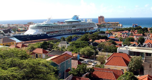 tui cruise lines marella discovery ship willemstad curacao caribbean ocean sea shore port city red ceramic rooftop skyline view outdoor day time sunny blue sky