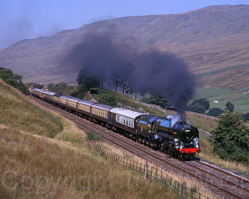 7th September 1991
British Railways Class 7MT 70000 Britannia heads south through Mallerstang towards Ais Gill summit at Angrholm on the Settle & Carlisle