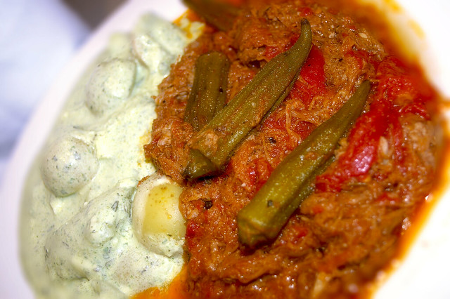 Greek-style stew with beef, tomato and herbs served with an okra garnish and potato salad
