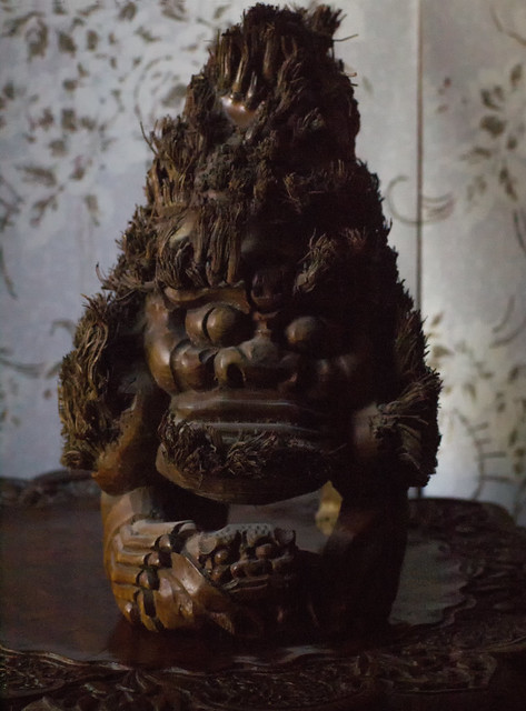 Demon deity on entranceway table