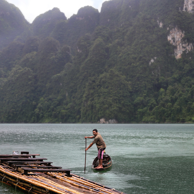 Forest Guard standup paddle boarding on a dugout canoe at Khao Sok
