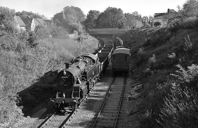 Standard Class 4MT Loco N0.80078 hauls a rake of 12 PNA Spoil wagons away from the mainline at Wymondham, after their delivery by 56103 of DC Railfreight. Mid Norfolk Railway 26 09 2018 bw
