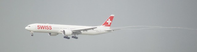 Swiss Internatonal Boeing 777 -300 HB-JNF arrives with streamer SFO runway 28 DSC_0361