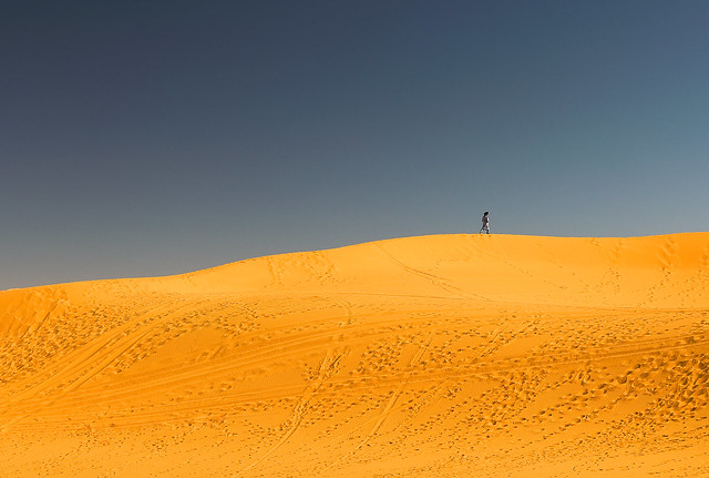 A berber walking along the Erg Chebbi sand dunes in Morocco.