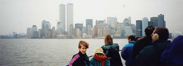 Steve and Casey on Ellis Island ferry, NYC skyline, including Twin Towers, in background, 1993
