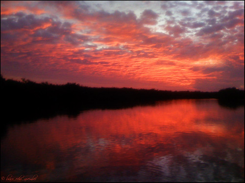 sunset red sky sun water clouds reflections evening twilight fishing florida iphone indianriverlagoon appleiphone