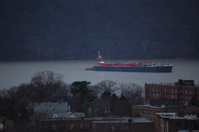 Overlooking Downtown Yonkers as Ship Sails Up Hudson River at Dusk